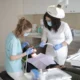 dentist in wayne county and assistant treating patient in chair