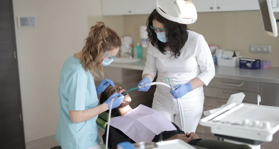 dentist in wayne county and assistant treating patient in chair