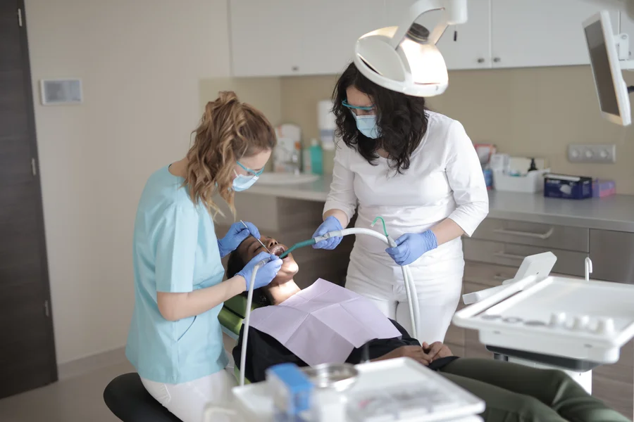 dentist in wayne county and assistant treating patient in chair